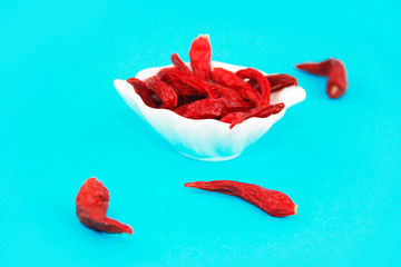 natural dried red small hot pepper in a decorative white plate