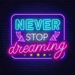 Plakat Never stop dreaming neon sign on a dark background.