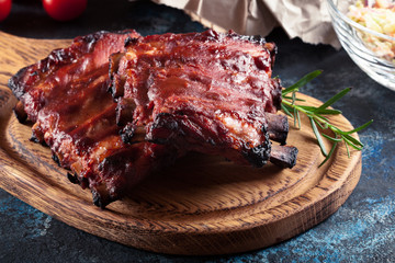 Spicy barbecued pork ribs served with BBQ sauce