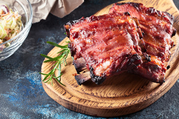 Spicy barbecued pork ribs served with BBQ sauce