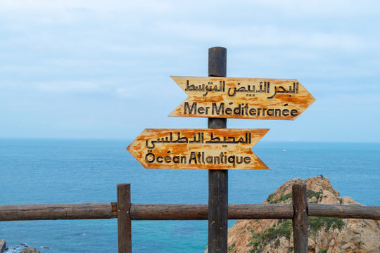 Signs indicating the place where the Atlantic ocean joins the Mediterranean sea near Tangier, Morocco