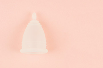 Close up of menstrual cup on pink background