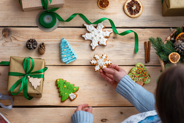 the view from the top. on a rustic, old table is a gift tied with ribbon and gingerbread