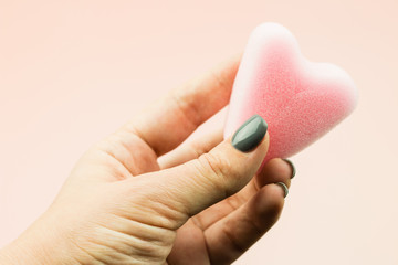 Close up of woman hand holding menstrual sponge tampon in packag