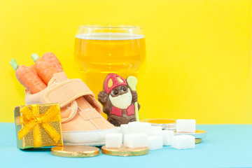 Shoe with carrot, sugar and glass of beer. Symbol of feast called Sinterklaas.