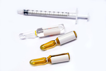 3 ml. brown Ampules of drug and plastic syringe on white background.