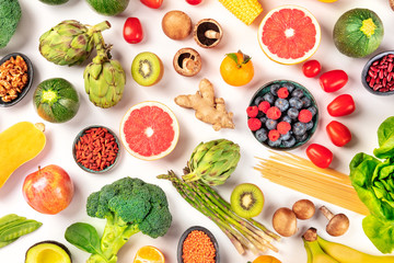 Vegan food. Healthy diet concept. Fruits, vegetables, pasta, nuts, legumes, mushrooms, shot from the top on a white background. A flat lay composition