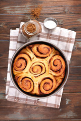 cinnamon brioche, cinnamon roll on wood background