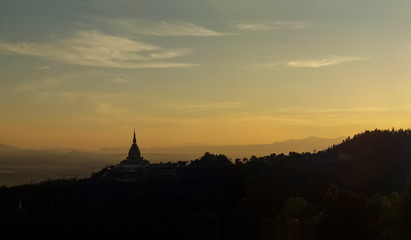 Fototapeta na wymiar Mountain view panorama evening of Crystal Pagoda or Chedi Kaew on top hill with yellow sun light in the sky background, sunset at Wat Tha Ton, Tha Ton District, Fang, Chiang Mai, northern of Thailand.