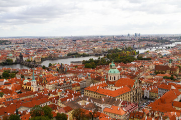 Naklejka na ściany i meble City views Prague autumn. Tiled roofs. The Charles Bridge. Vlatva river