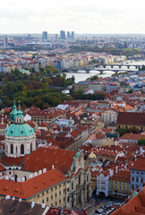 Fototapeta na wymiar City views Prague autumn. Tiled roofs. Bridges. Vlatva river