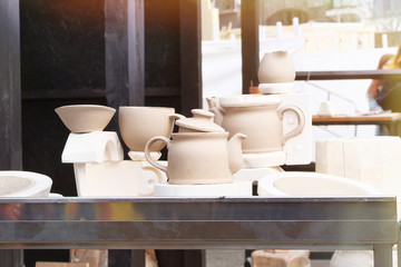 Handmade clay pots after potters wheel. Pottery, and craftsmanship concept. Workshop for handicraft.