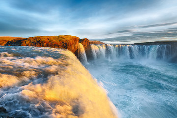 Fantastic sunrise scene of powerful Godafoss waterfall.