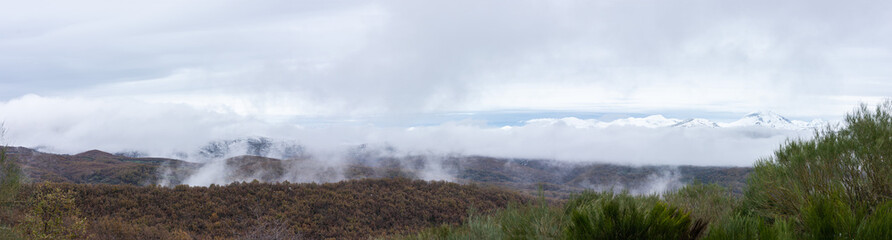 panoramic snowy mountain range and cloud cover