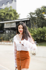 Portrait young asian woman walking on the street