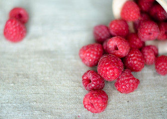 Fresh raspberry in a wooden plate with wooden spoon. Rustic style. Close up. Zero waste concept