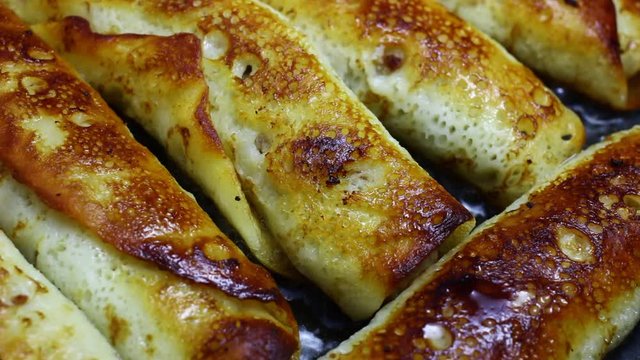 Pancakes stuffed with frying in a frying pan