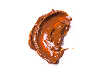 Melted tasty caramel splashes isolated on white background.