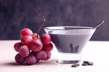 Black yogurt with activated carbon and red grapes