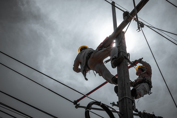 The lineman are replacing damaged insulator insulators by using insulated wire-tong sets, tie stick...