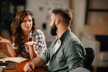 Colleagues in office. Businesswoman and businessman discussing work in office. Two friends in working together.  