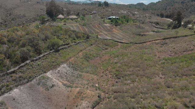 Traditional compound in mountainous rainforest by drone