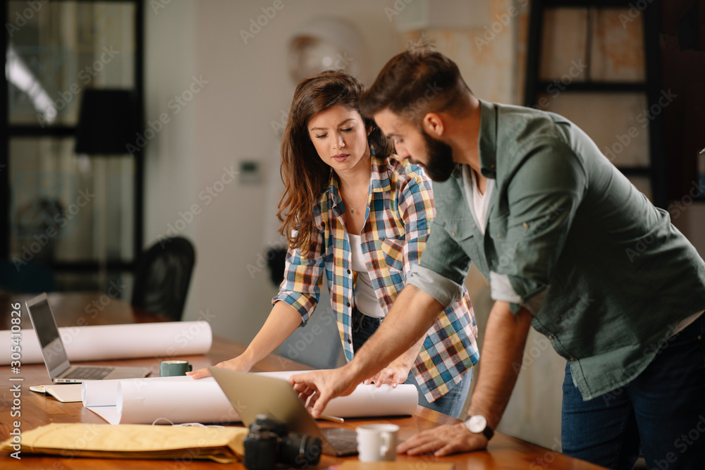 Wall mural colleagues in office. businesswoman and businessman discussing work in office. two friends in workin