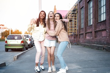 Outdoor shot of three young women having fun on city street