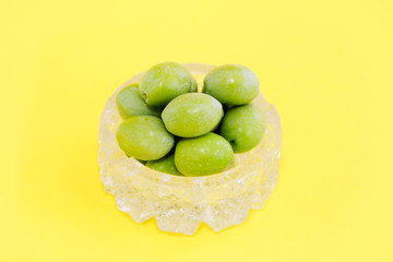 natural round green olives in a decorative glass plate