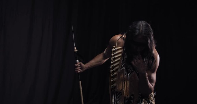 Sad native american indian with his head down, wearing traditional clothes, 4k