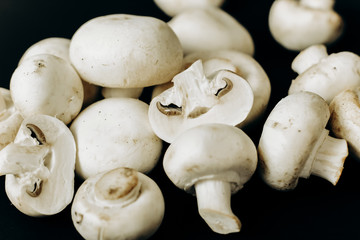 champignon mushrooms on a black background. space for text