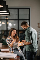Colleagues in office. Businesswoman and businessman discussing work in office. Two friends in working together.  