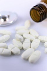 pills and bottle on white background