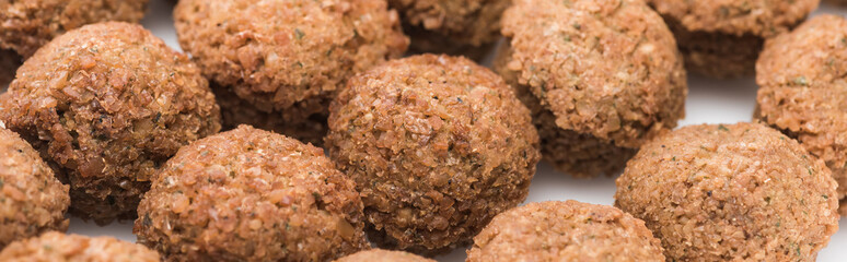 close up view of fresh cooked falafel balls on white background, panoramic shot