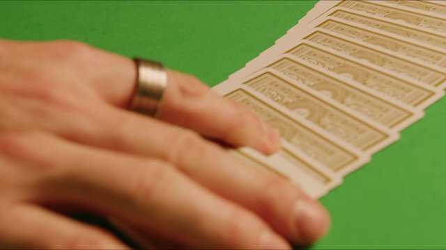 Magician shows tricks with cards, slow motion shot, flying cards, magic and illusion, isolated, shot on Red Weapon Helium