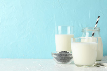 Glass of chia milk and chia seeds on blue background, space for text. Closeup