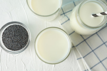 Glass of chia milk and chia seeds on blue background, space for text. Top view