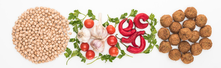 top view of chickpea, garlic, cherry tomatoes, parsley, chili pepper and falafel on white background, panoramic shot