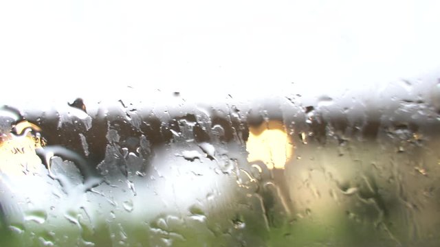 Rain falling on surface of the window.