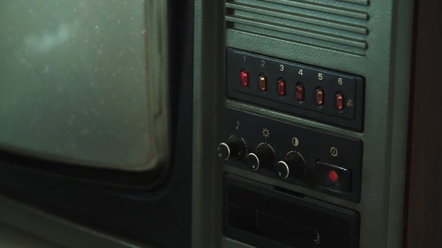 Turning on old Tv, white noise and snow on screen