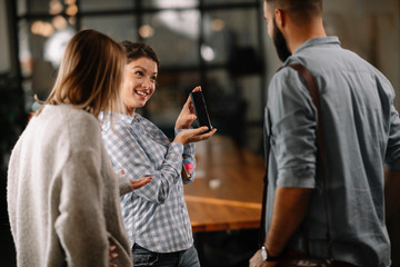 Colleagues having fun in office. Business people talking at workplace. 