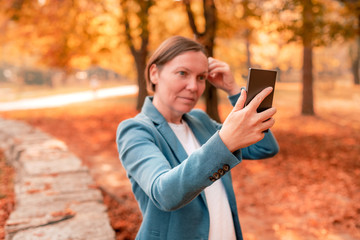 Businesswoman making selfie with smartphone
