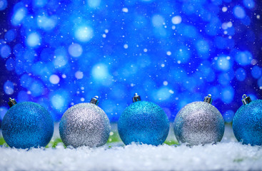 Christmas card.Christmas Toys in the snow with a bright background, and falling snow.