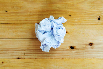 Close up white paper crumpled on wooden background