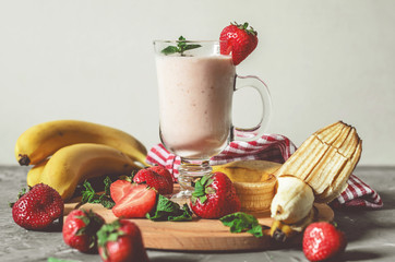 banana and strawberry smoothies with mint on the table, front view - 305420283