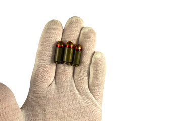 Hand in white glove holds three bullet on finger tips. Isolated closeup on white background. Concept of crime investigation, ballistics or arms and gun shop. Clue proof in expert hand