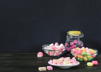 multi-colored candies in a plate, bank and bowls with copy space - 305420461