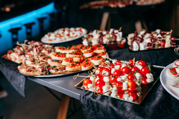 Luxury food and drinks on corporate party table.