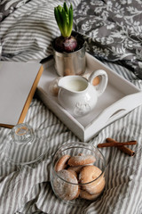 cozy evening with a book and cookies under the covers. Interior details. Coffee in bed