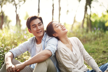 young asian couple relaxing in park